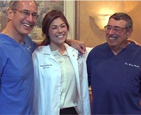 All three Dr. Brooks smiling togetehr