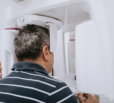 Man getting a cone beam CT scan of his mouth and jaws