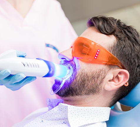 Man getting professional teeth whitening in the dental chair