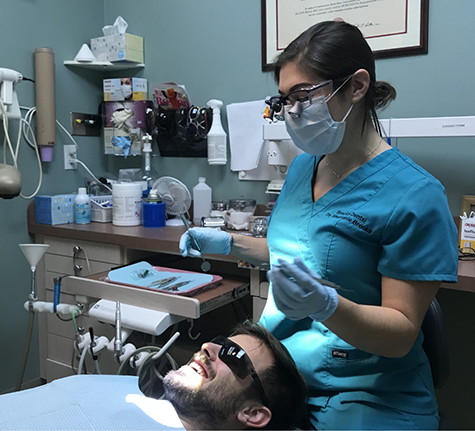 Dentist chatting with a patient during a checkup