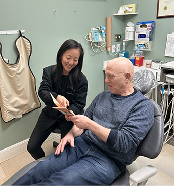 Dentist showing a pamphlet to a patient