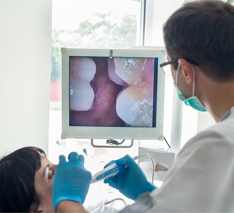 Dentist capturing close up photos of a patient's teeth and gums