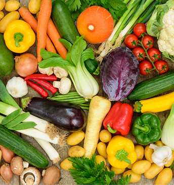 Table covered in fresh fruits and vegetables