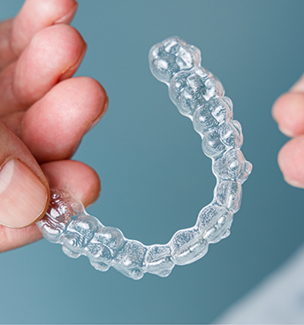 Clear aligner in a person's hand