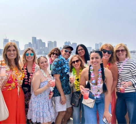 Doctor Stephanie on a vacation with several people wearing tropical themed clothing