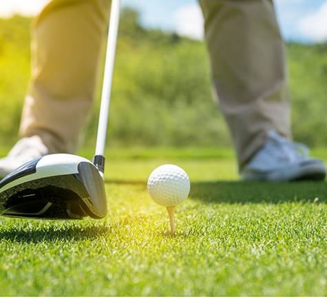 Golfer about to hit a ball
