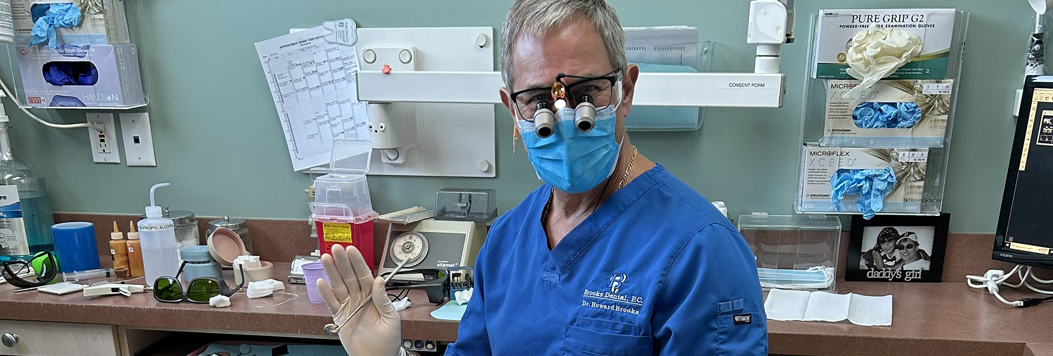 Winthrop dentist Doctor Howard Brooks waving while wearing personal protective equipment