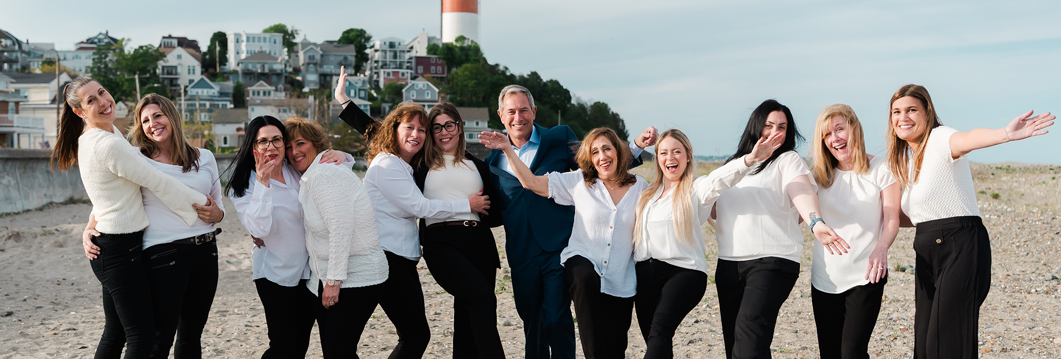 The Brooks Dental team smiling on a beach