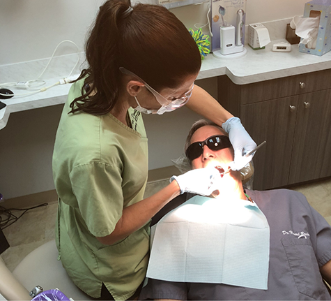 Dentist giving a patient a preventive dental exam