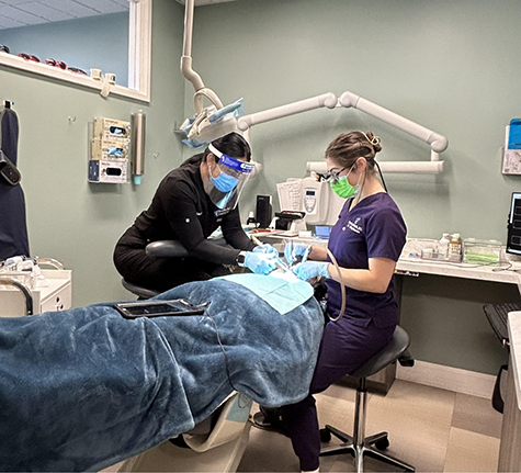 Dentist and assistant treating a patient
