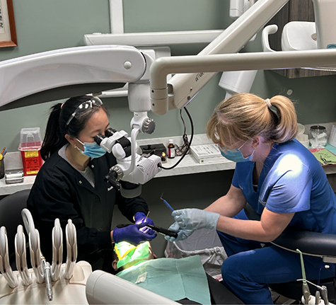 Dentist and assistant performing a dental procedure on a patient