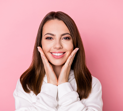 Smiling woman framing her face with her hands