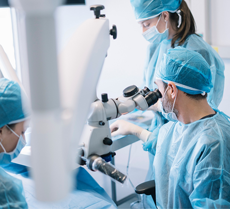 Three dental professionals performing a procedure on a patient