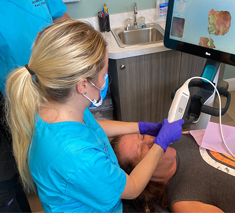 Dentist taking scans of a patient's teeth
