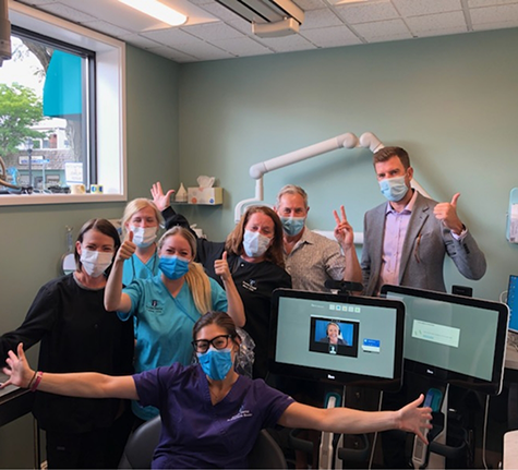 The Brooks Dental team all giving peace signs