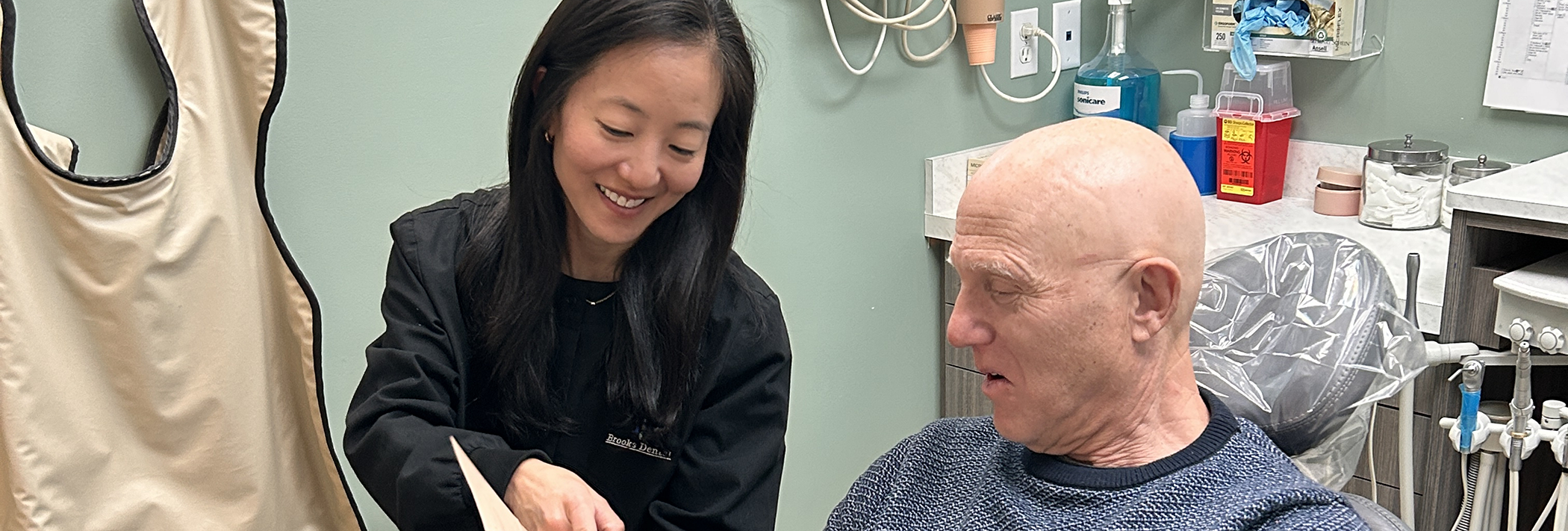 Winthrop endodontist Doctor Andrea Shah showing a screen to a patient